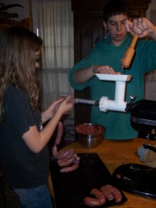 a mom and son making deer sausage