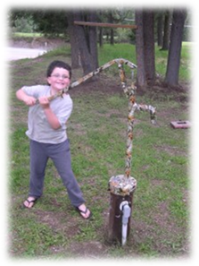 a boy using a bison hand water pump