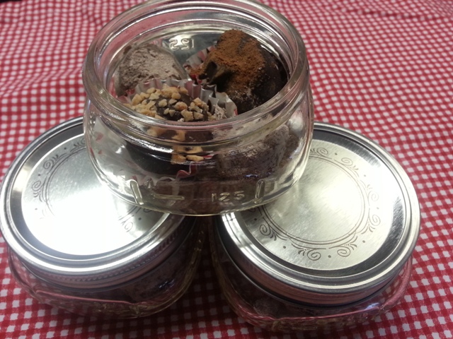 chocolate truffles and peanut butter truffles in small mason jars