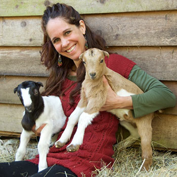Corina Sahlin holding two baby milk goats