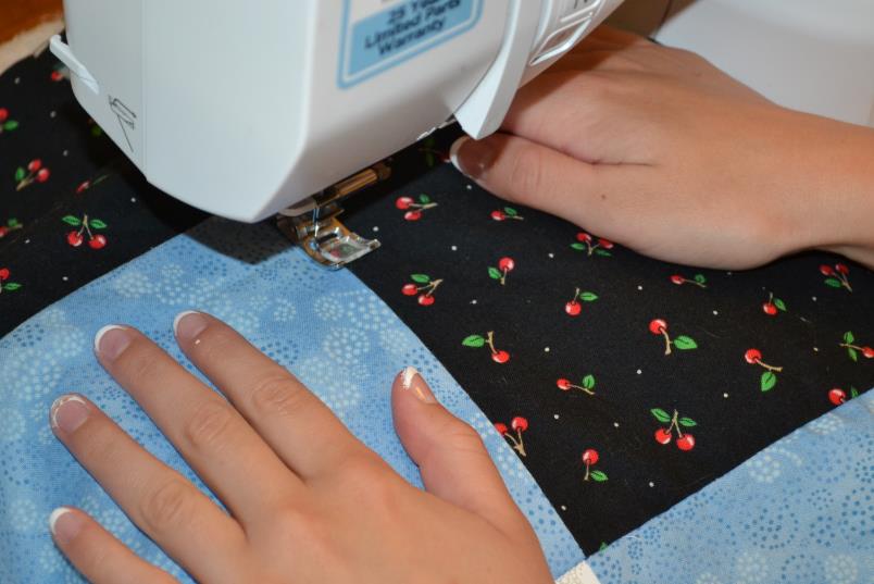 showing how to make a quilt front by sewing quilt squares together